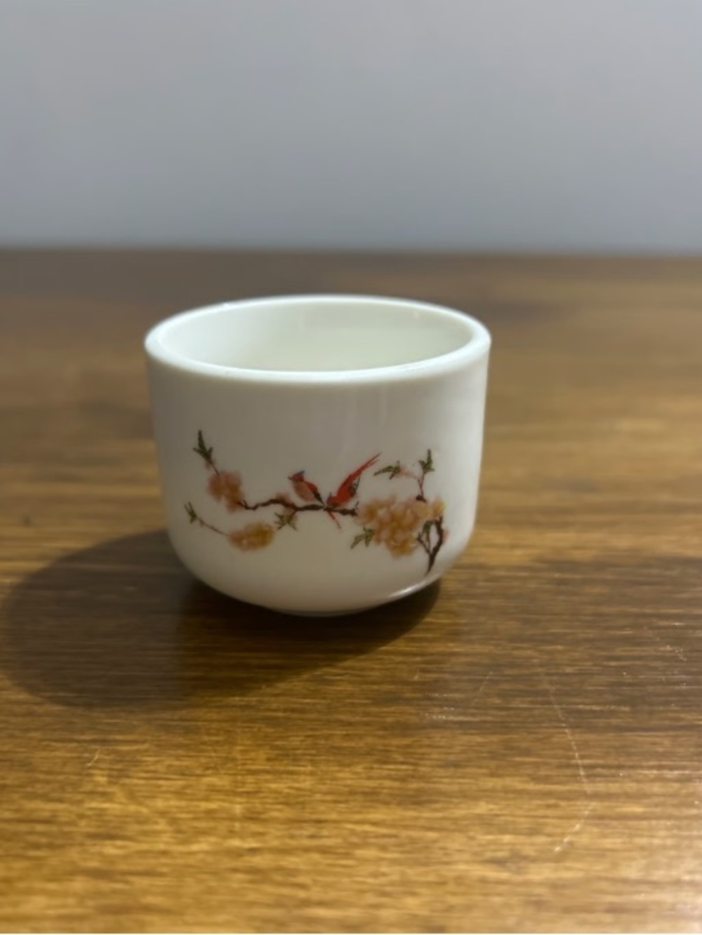 White Porcelain Cup with Red Bird and Floral Motif